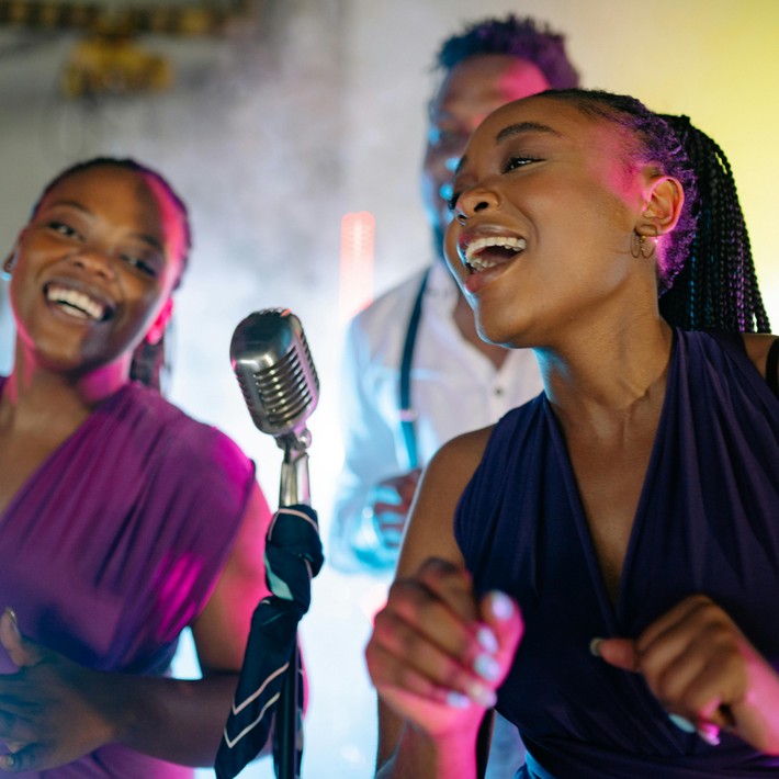 Team singing together on stage during corporate karaoke night in Ireland