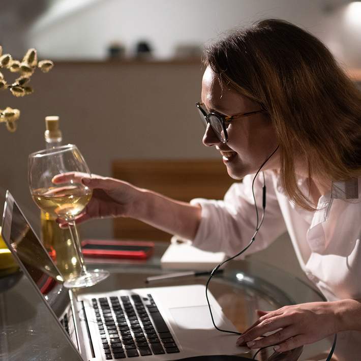 woman wine tasting on video call