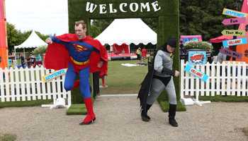 men dressed as superman and batman