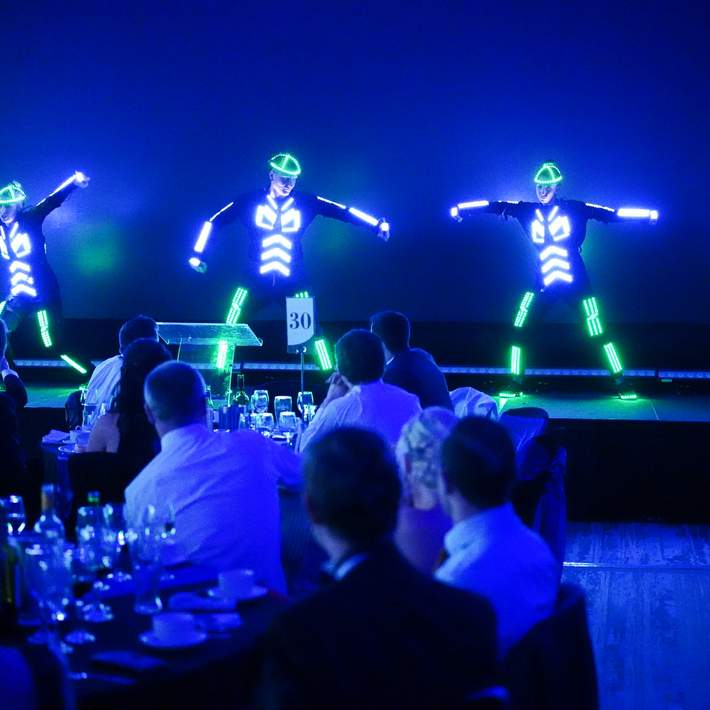 dancers in LED suits on stage at launch event