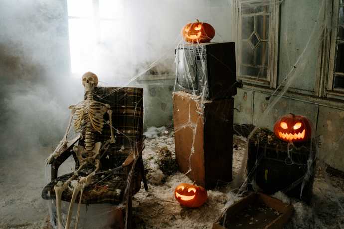 abandoned building with a skeleton and pumpkins