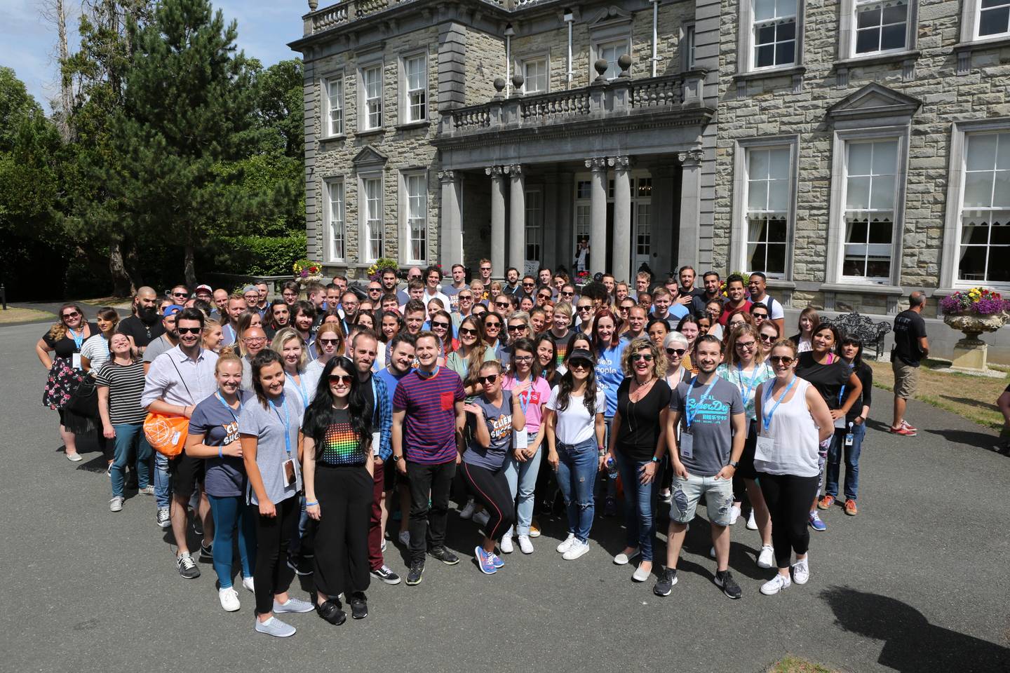 group of people standing in front of manor house