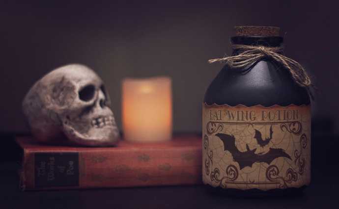 A potion, a skull and a candles lighting