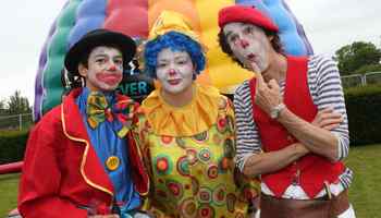 Clowns in front of hot air balloon