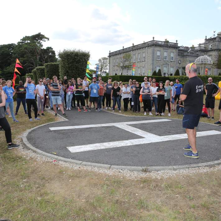 group standing beside heli pad