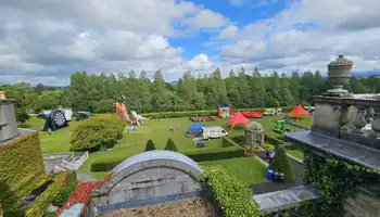 Overview of event set up from the roof of palmerstown house with blue skies.