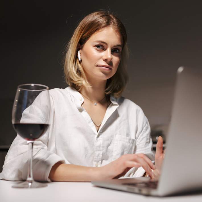 woman on laptop with wine