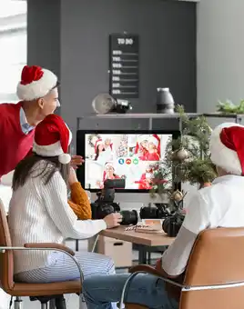 Corporate team enjoying a hybrid virtual Christmas party with festive decorations