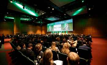 Corporate kick-off event with a large audience attending a keynote presentation in a modern conference venue in Ireland.