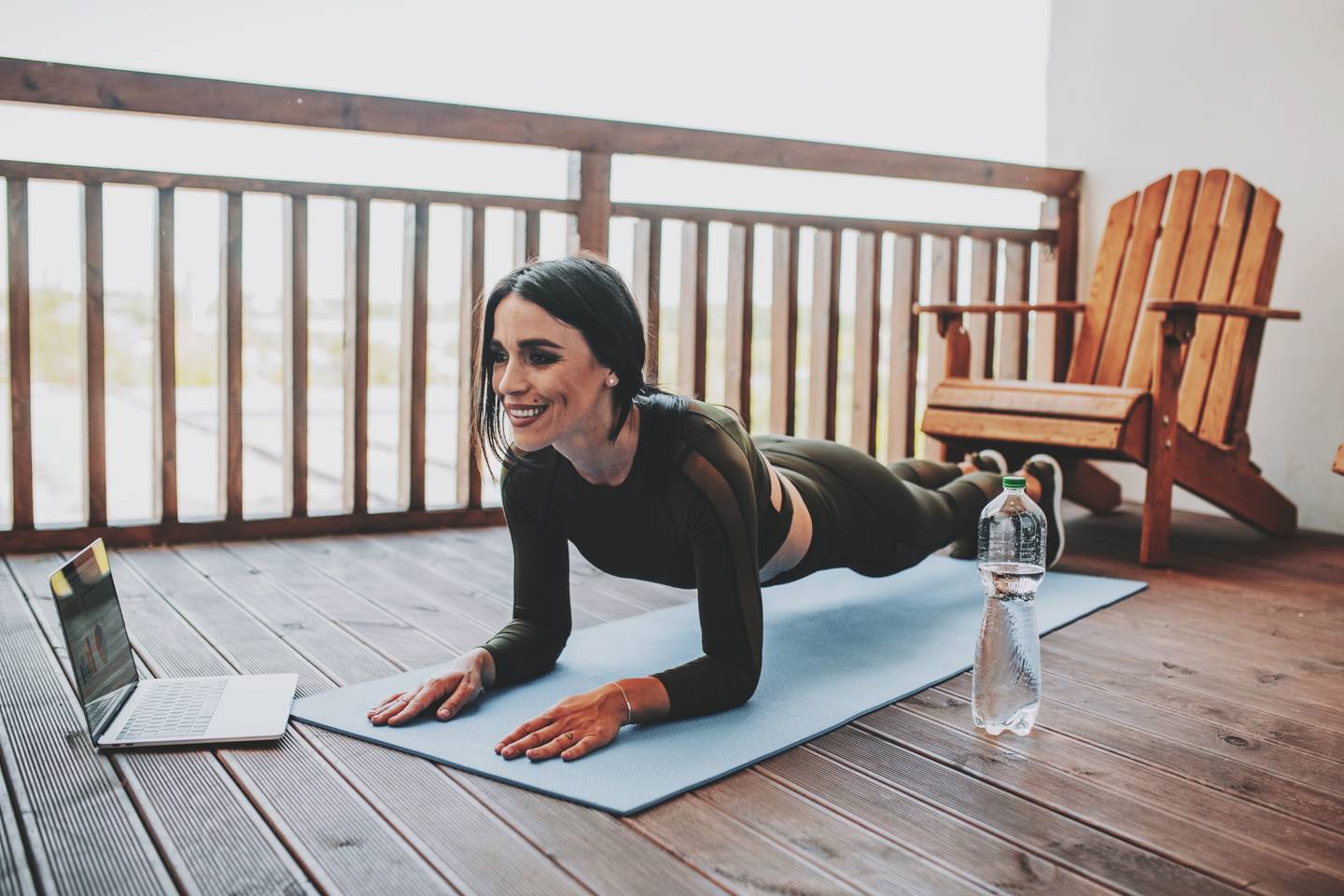 woman exercising on balcony at home