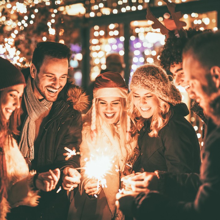 people lighting sparklers at Christmas