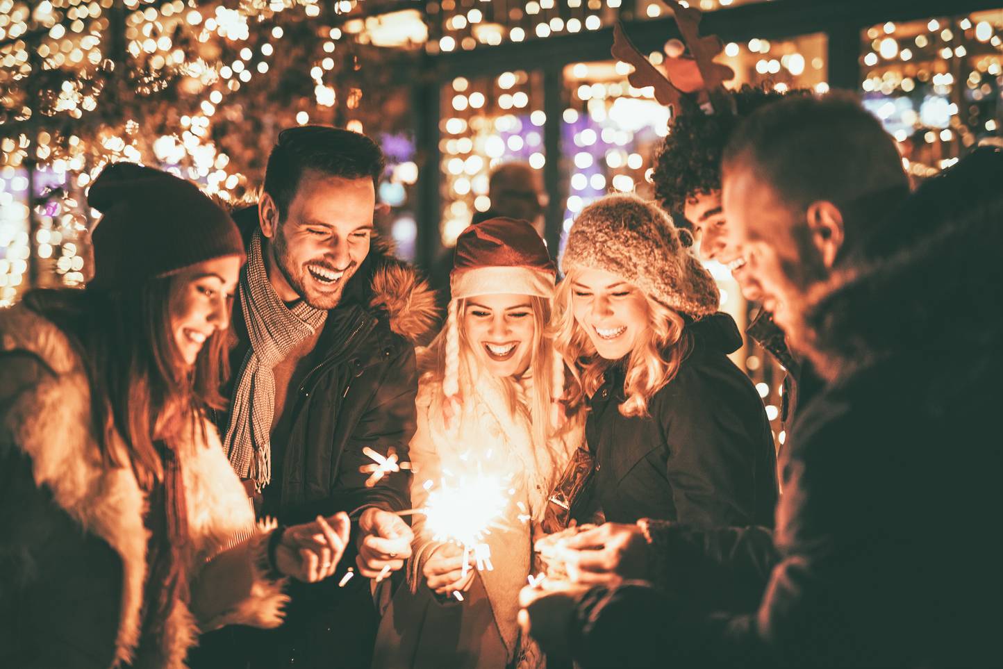 people lighting sparklers at Christmas