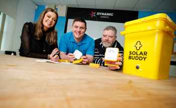 Employees engaged in assembling solar lights during a SolarBuddy activity for communities without electricity