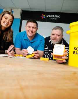 Employees engaged in assembling solar lights during a SolarBuddy activity for communities without electricity