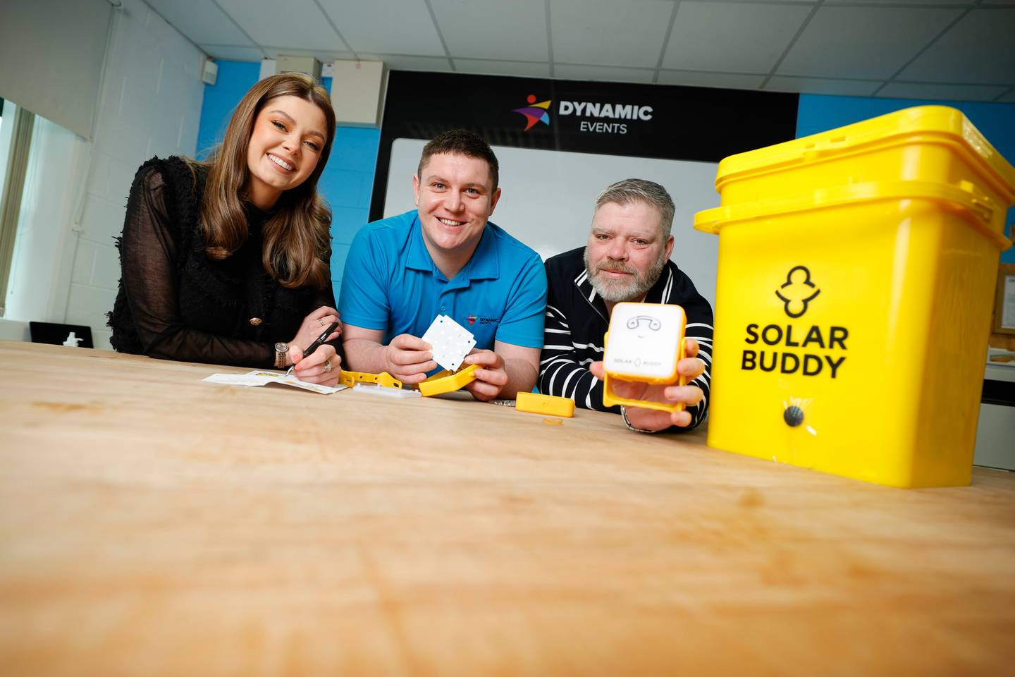 Employees engaged in assembling solar lights during a SolarBuddy activity for communities without electricity