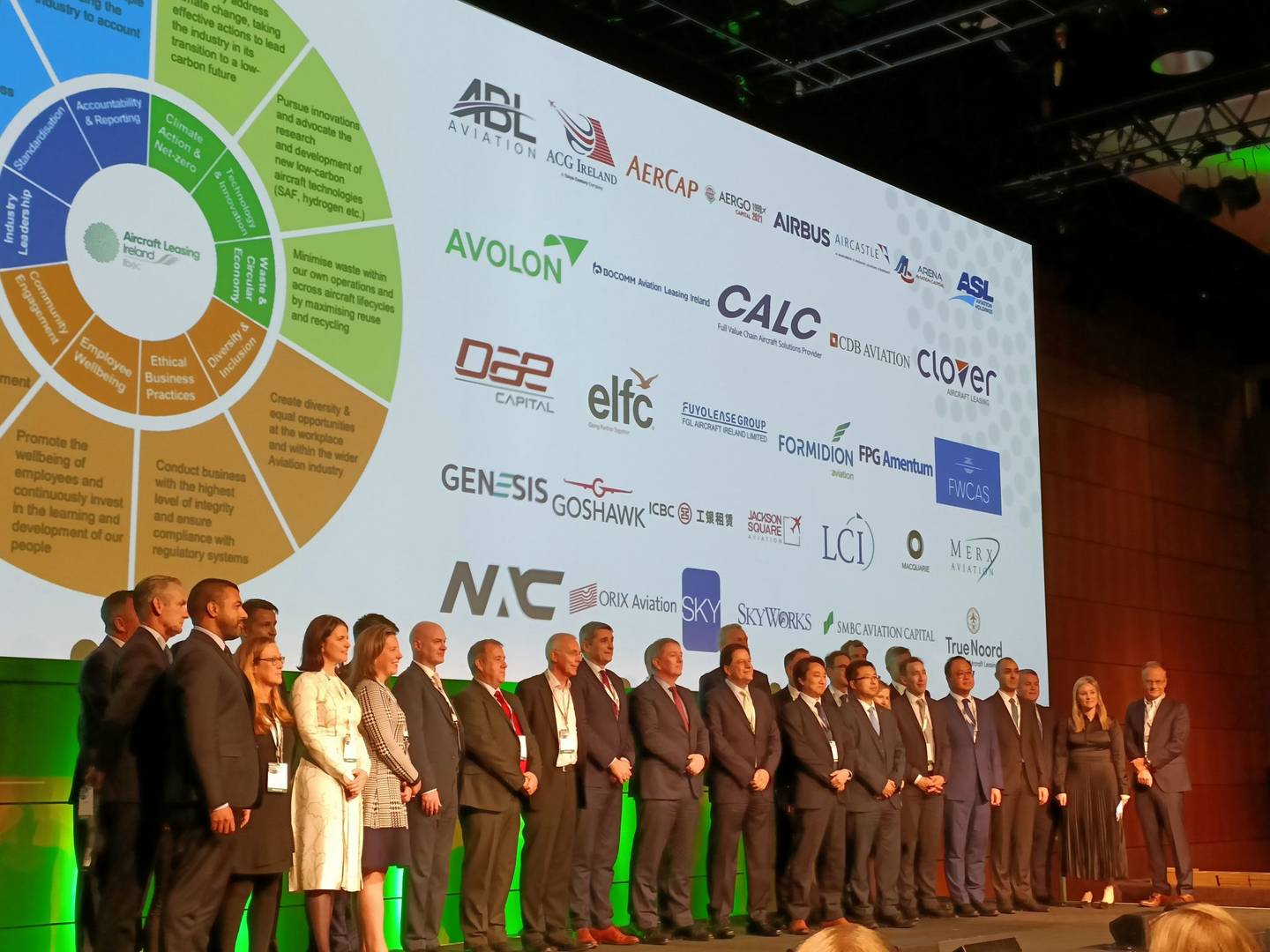 group of delegates standing on stage