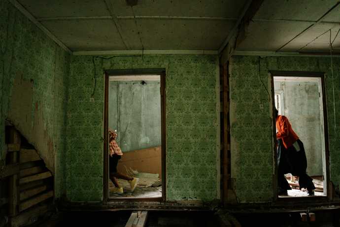 People running through an abandoned house