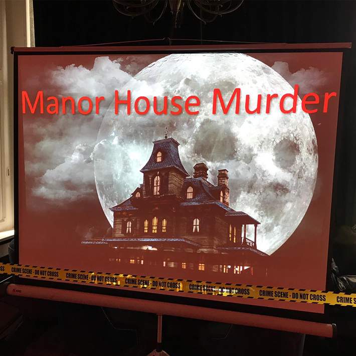 A projector screen displays Manor House Murder with a spooky mansion and full moon backdrop, setting the scene for a gripping corporate team-building mystery event. Yellow crime scene tape adds to the immersive experience, instantly drawing teams into the challenge.