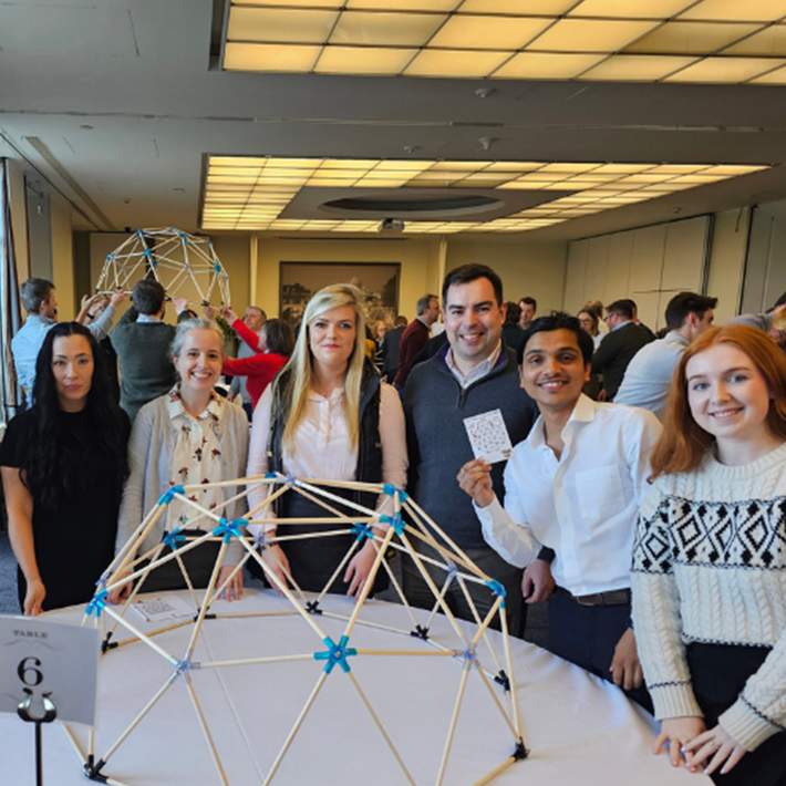 group posing with dome