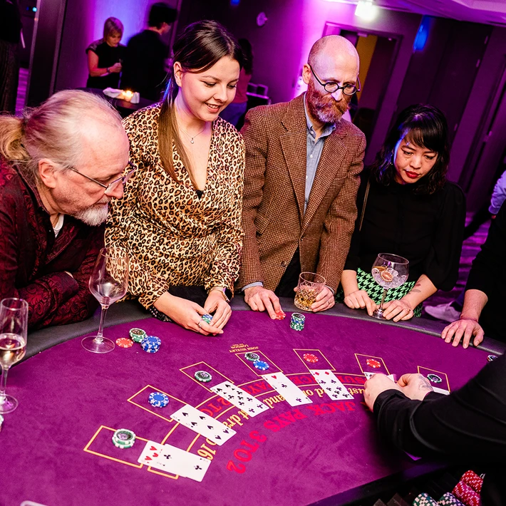 Corporate casino team building night in Dublin with colleagues playing blackjack at professional tables
