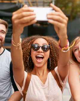 group smiling for selfie