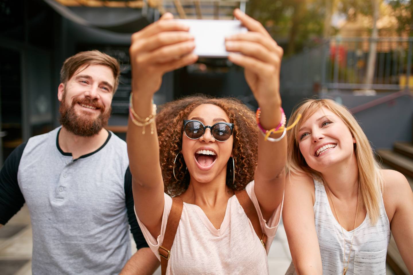 group smiling for selfie