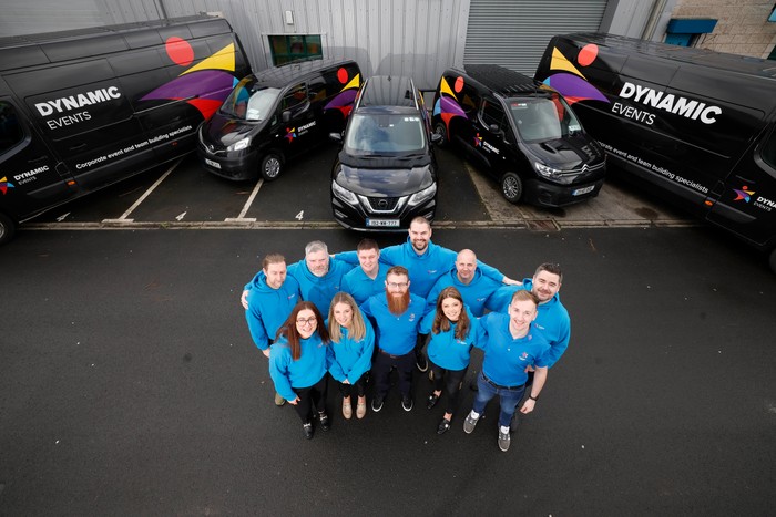 Group in front of Dynamic Events vans