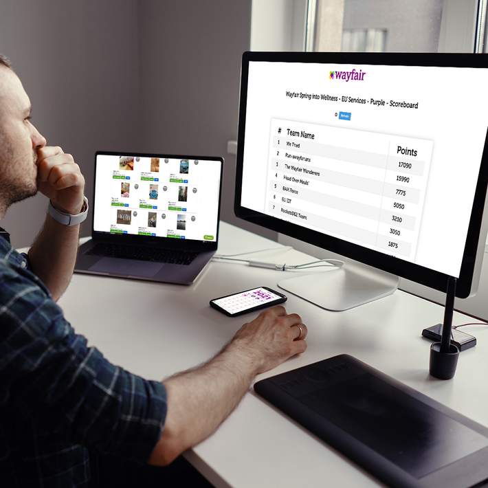 man sitting at desk with computers