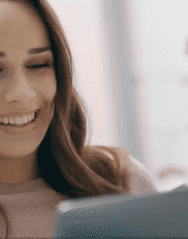 woman smiling at laptop screen