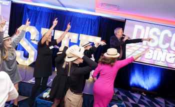 Christmas team building event with colleagues playing Disco Bingo and having fun