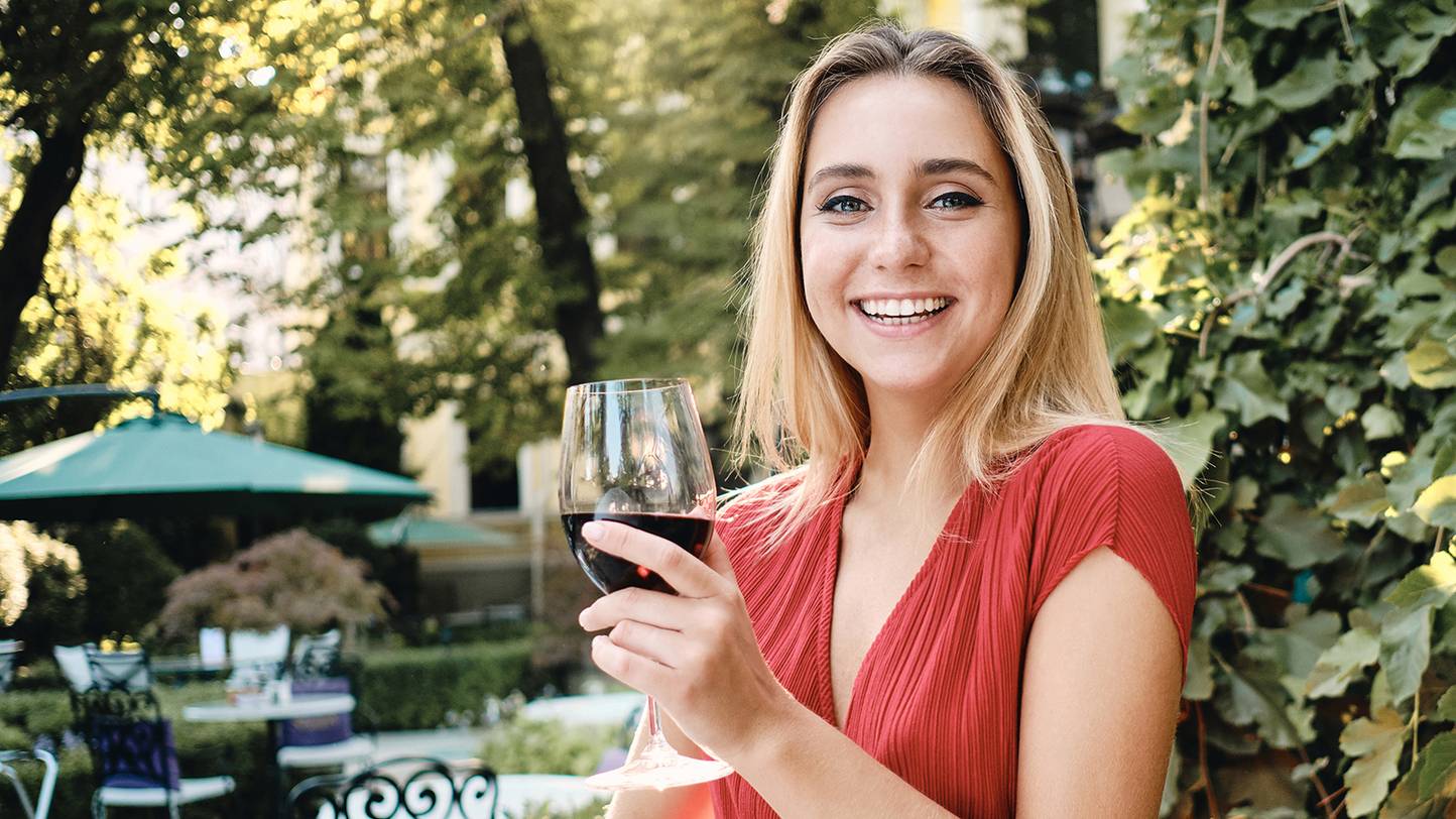 happy blond woman drinking wine